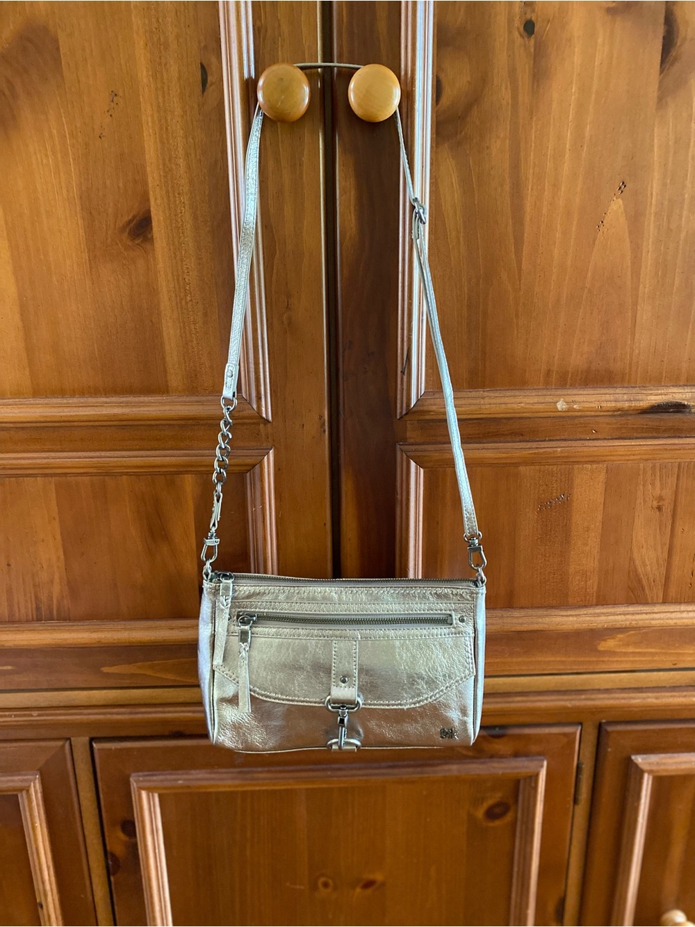 The Sak Metallic Silver Crossbody with Front Zipper and Chain Strap